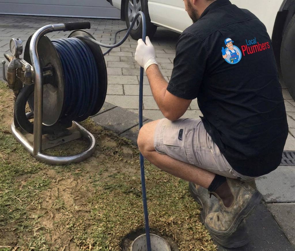 Local plumber working on plumbing equipment